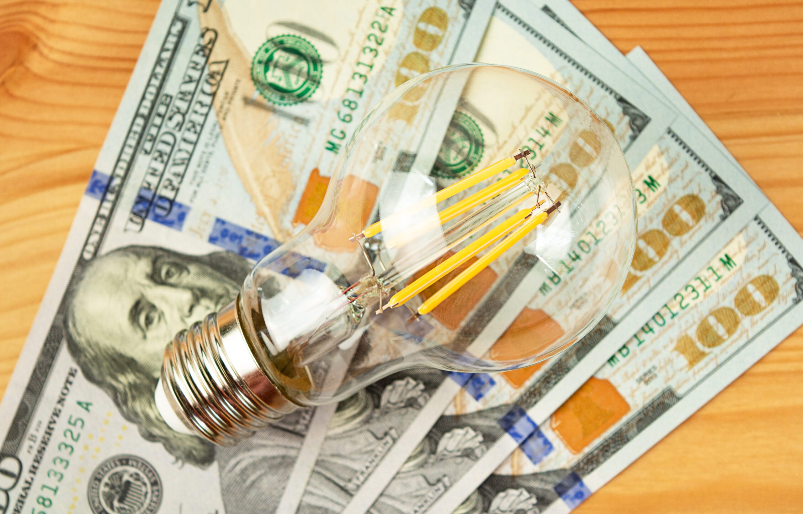 The concept of paying utility bills. Business concept. A lamp and dollar bills on the table. View from above. Up close
